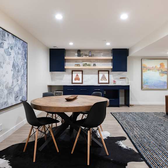 a living room and dining room with a table and chairs