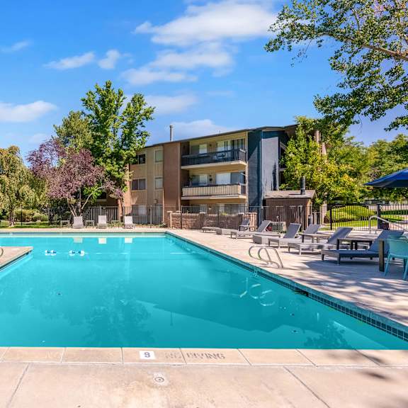a swimming pool with a building in the background