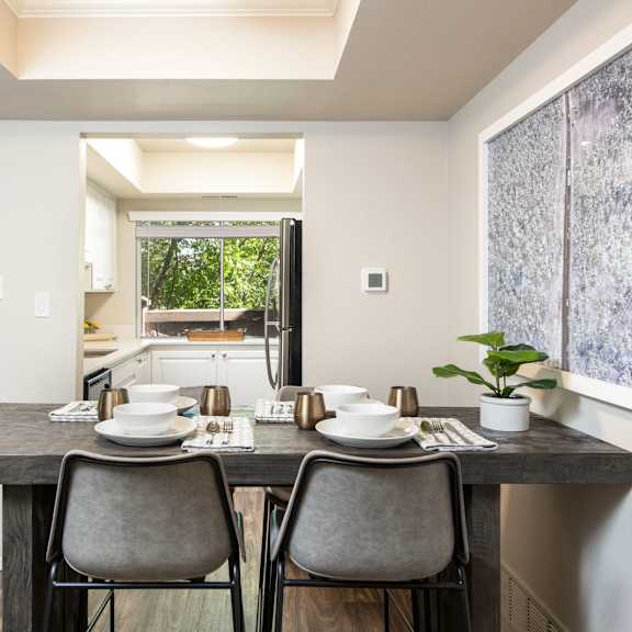 a kitchen and dining room with a table and chairs