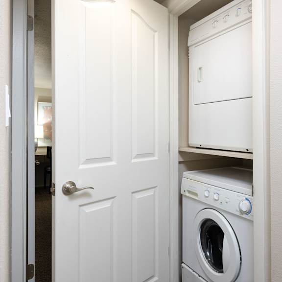 a white washer and dryer in a small laundry room