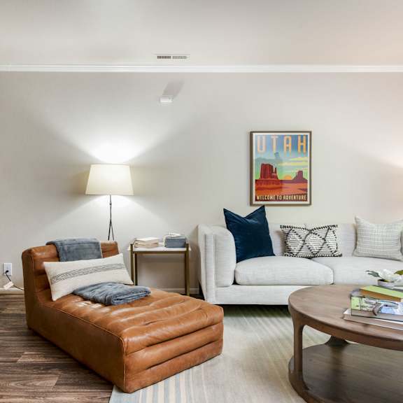 a living room with a couch and a chair and a table