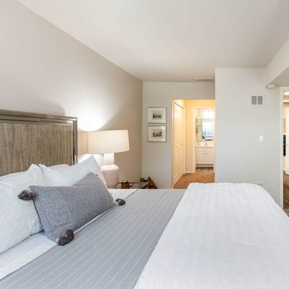 a bedroom with a large bed and a closet