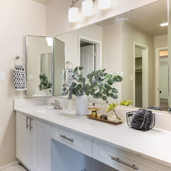 a bathroom with a large mirror and a toilet