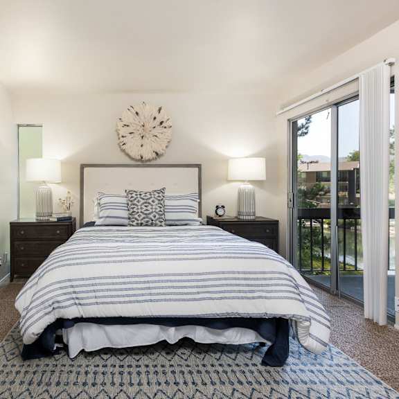 a bedroom with a bed and a window