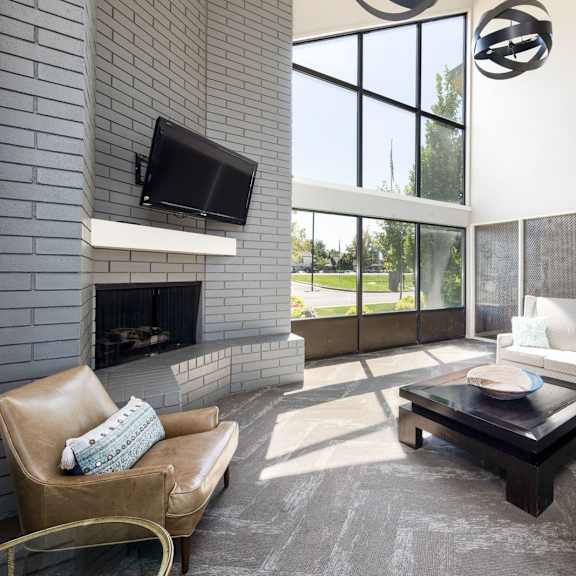a living room with a couch and a table and a fireplace