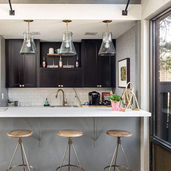 a kitchen with a counter and bar stools