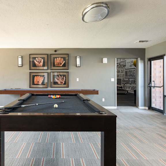 a room with a pool table in the middle of it