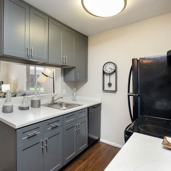 an open kitchen with a sink and a refrigerator