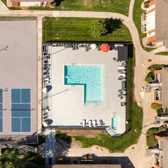 arial view of a building with a pool on the side of it