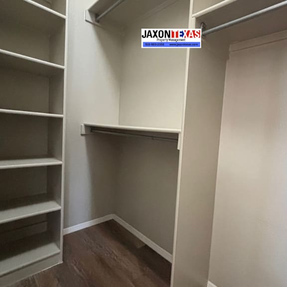 a walk-in closet with shelves