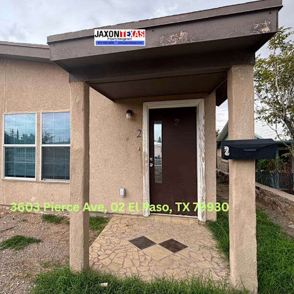 the image shows the front of a building with a sign that reads "jaxonix" and a door with a number 2 on it.
