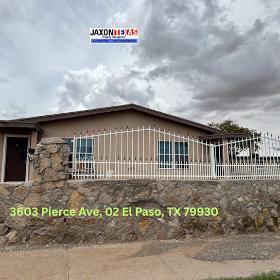 a house with a stone wall and a sign that says jaxones in the background.