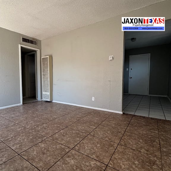 a room with a tiled floor and a door on the left.