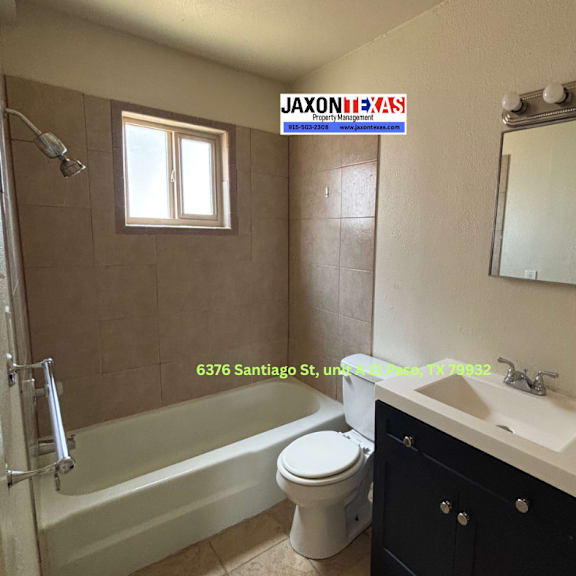 a bathroom with a white toilet, a white sink, and a bathtub.