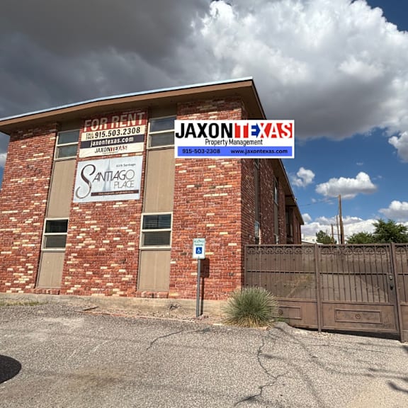 a building with a sign that says "jaxon property management" in front of it.