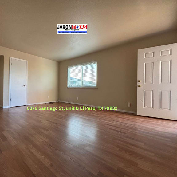 empty room with wooden floors and white doors.