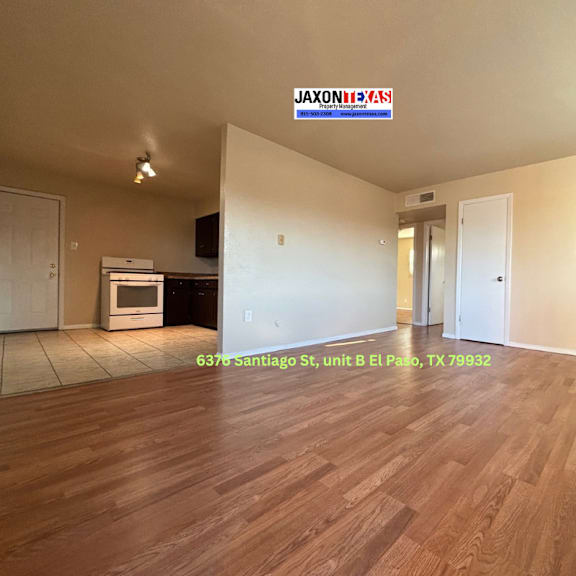 empty room with wooden flooring and a jaxon reds sign on the wall.