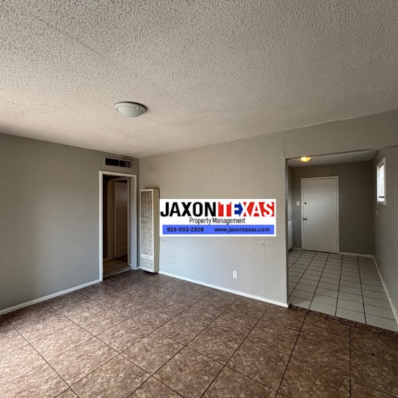 a room with a jaxon property management sign on the wall.