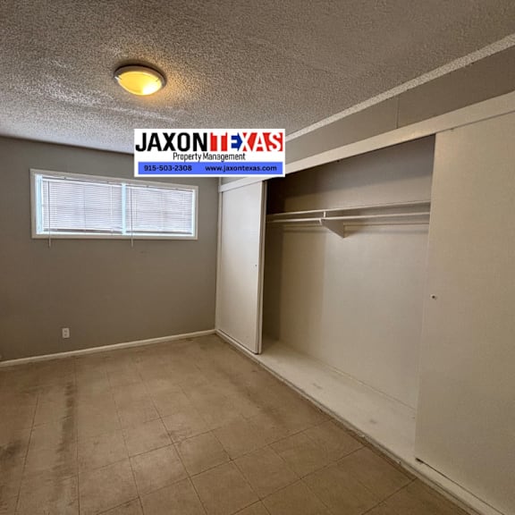 a room with a sign that says "jaxon property management" on the wall.