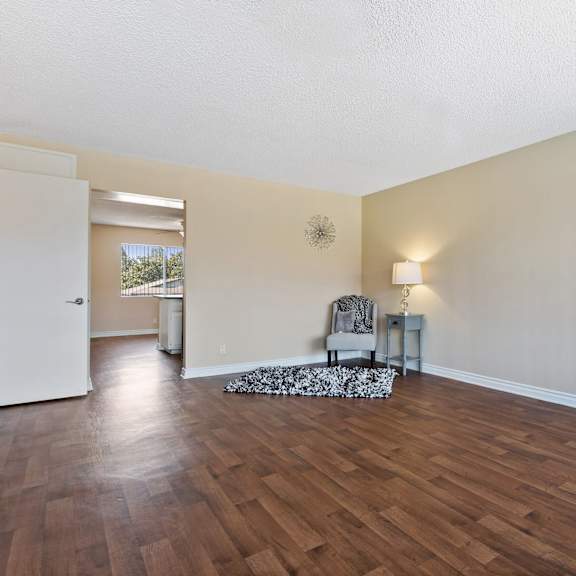 the spacious living room and dining room with hard wood flooring at terramonte apartment homes, pomona, ca, 91767