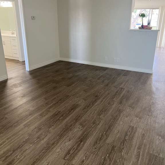 a room with wooden flooring and white walls.