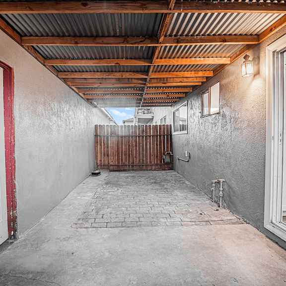 a long hallway with a white door on the left and a white door on the right.