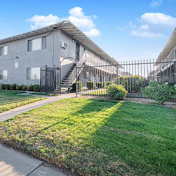 a residential area with a house and a fence.