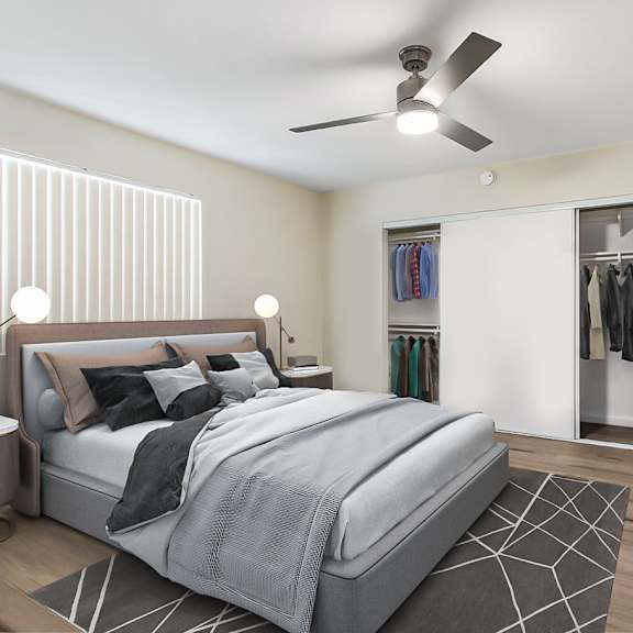 a bedroom with a large bed and a ceiling fan.
