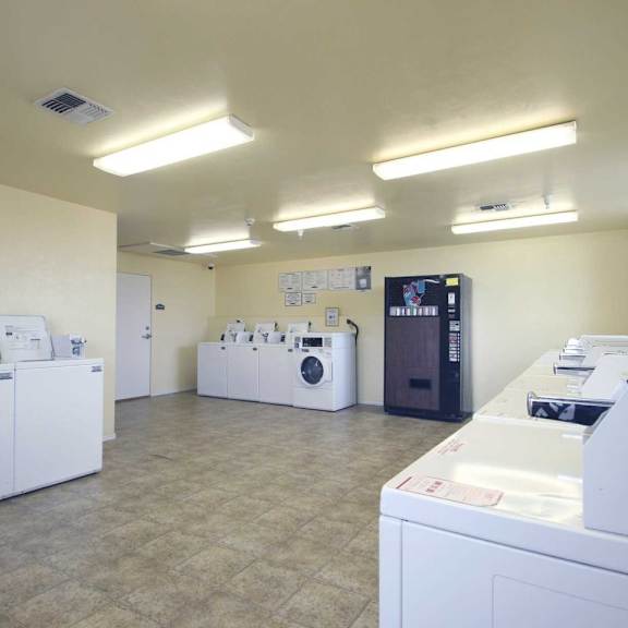 a laundry room with washers and dryers.