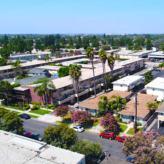 a view of a residential area with houses, trees, and cars.