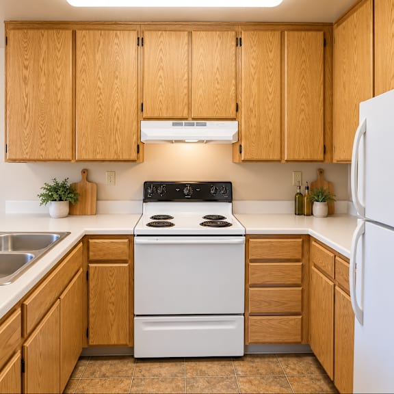 a kitchen with wooden cabinets and a white stove.