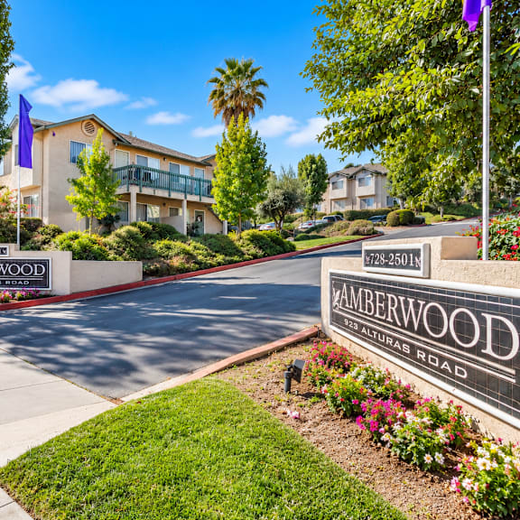 a sign for amberwood apartments is displayed in front of a building.