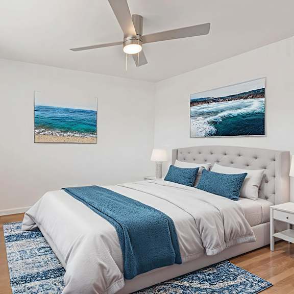 a bedroom with a large bed and a ceiling fan.