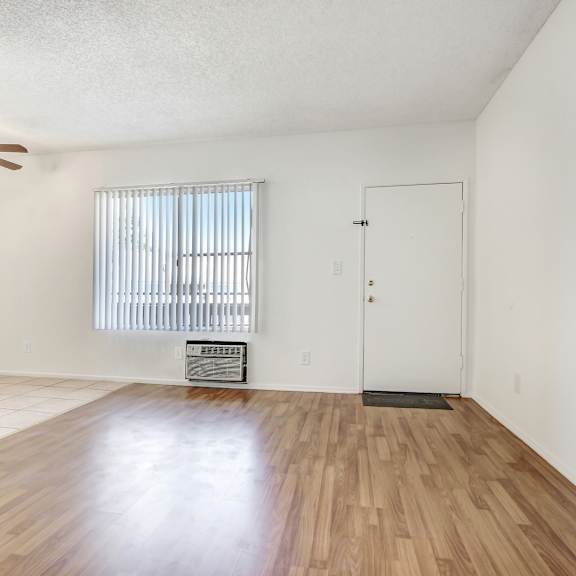 a room with wooden floors and a ceiling fan.