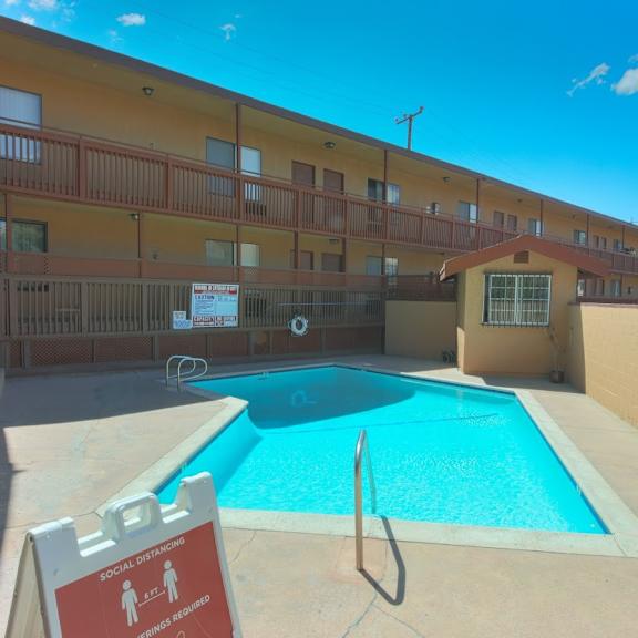 a pool with a sign that says social distancing.