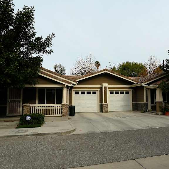 a house with a brown roof and a white garage door.