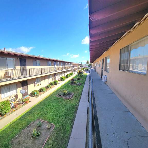 a sunny day at a residential complex with a clear blue sky.
