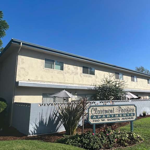 a building with a sign that says "carmelton pacifica apartments" in front of it.