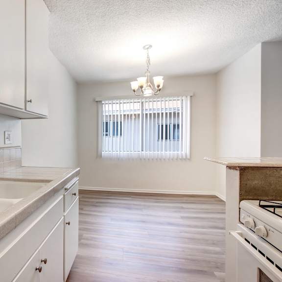 a kitchen with white cabinets and a beige countertop.