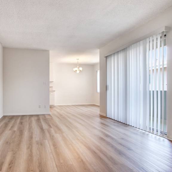 a room with wooden flooring and white walls.