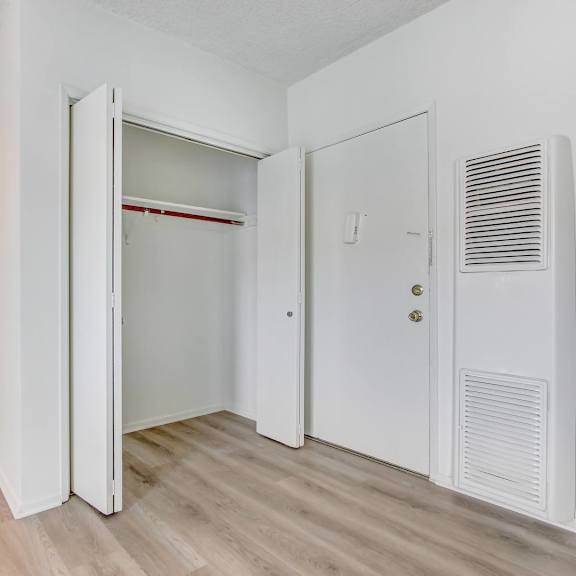 a white room with a mirror and a door.