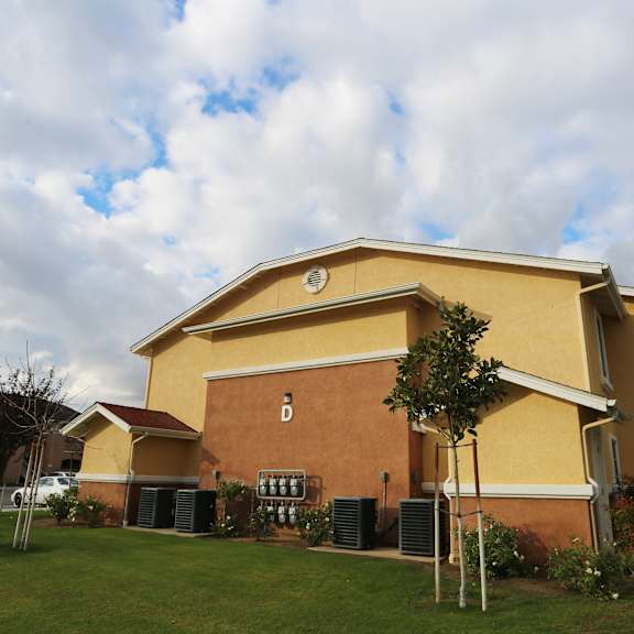 a yellow building with a sign that says d on it.