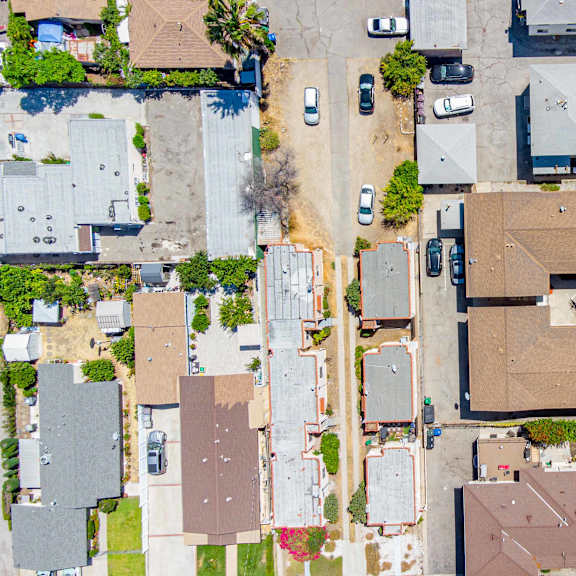 a bird's eye view of a residential area with houses and cars.
