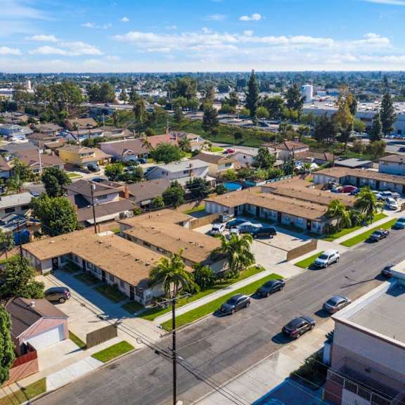 a residential area with houses and parked cars.