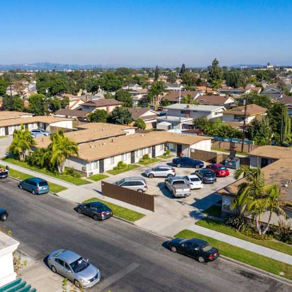 a residential street with cars parked on both sides.