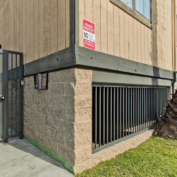 a red and white sign on a building reads "no parking".