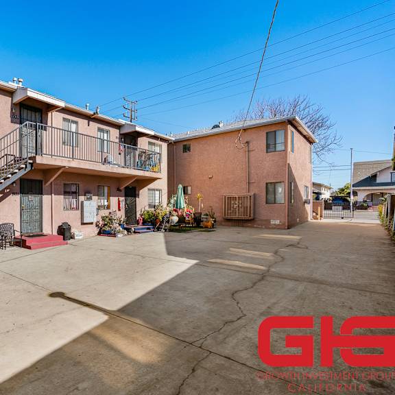 a sunny day at a residential complex with a clear blue sky.