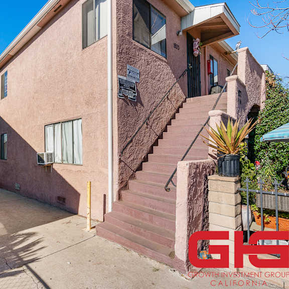 a house with a staircase leading to the front door.