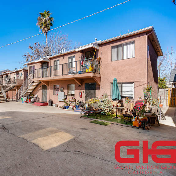 a sunny day in a residential area with a house and a clear blue sky.
