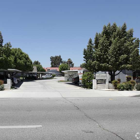 a street view of a residential area with houses and trees.